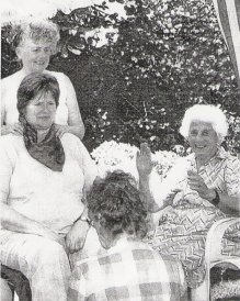 Picture of Dottie Hook giving herbalist Jenny Boys a massage in the garden of Ailsa Lawrence.